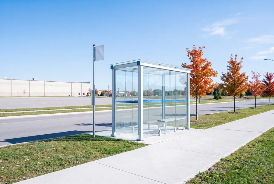 Empty bus shelter on a suburban road in autumn